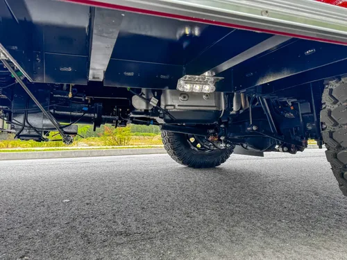 Undercarriage low-angle view showing rear axle and frame beneath the truck.